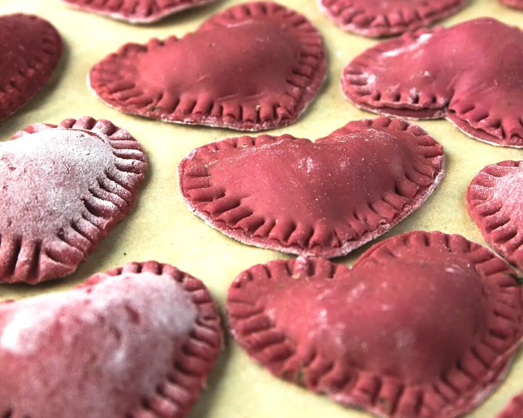 Heart-shaped red ravioli, a romantic Italian pasta dish for Valentine’s Day