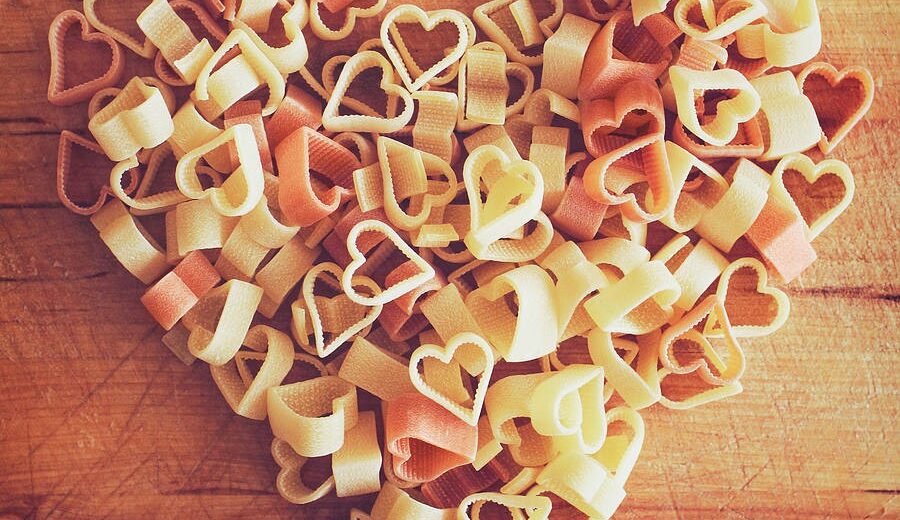Heart-shaped pasta arranged on a wooden board for Valentines day in Italy