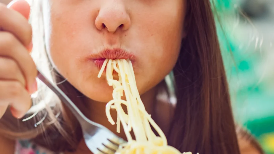 woman eating pasta