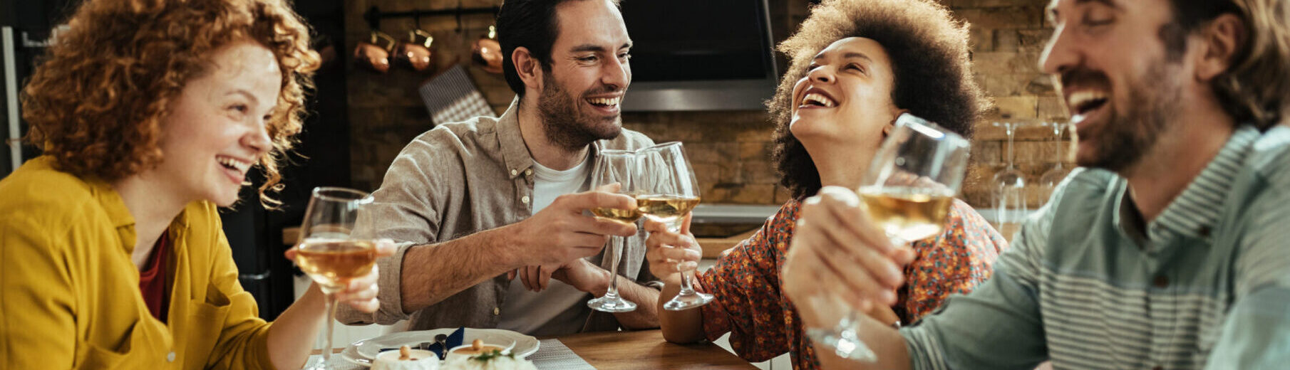 happy-couple-toasting-with-wine-having-fun-with-their-friends-dining-table