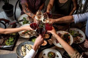 friends eating and drinking wine in traditional italian setting